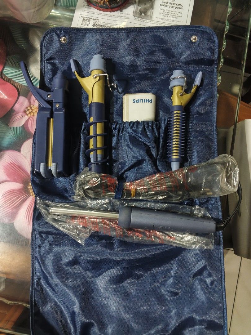 Philips Hair Styling Set with Multiple Attachments (Category: Hair) located in Caloocan City. Submitted by fastriver-4c93 (Listing ID 1463408781, Image 3). Description: - Philips hair styling set - Includes curling wands and a straightener - Comes with a blue travel pouch featuring the Philips logo - Some items are still in original packaging - Ideal for on-the-go styling.