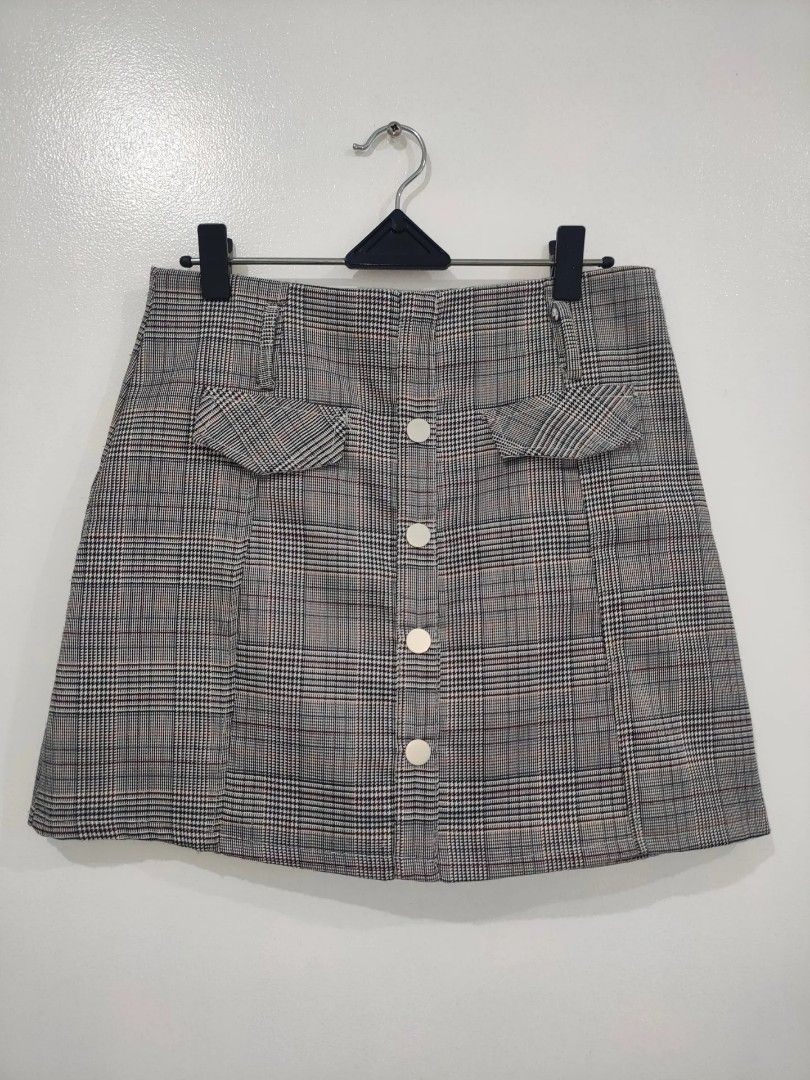 Plaid Button-Front Mini Skirt with Pockets (Category: Skirts) located in Quezon City. Submitted by maxsab (Listing ID 1463549444, Image 1). Description: - Cute plaid mini skirt - Grey, white, and red color palette - Button-front closure - Two front flap pockets - Pairs well with tops or sweaters - Suitable for casual or dressed-up looks.
