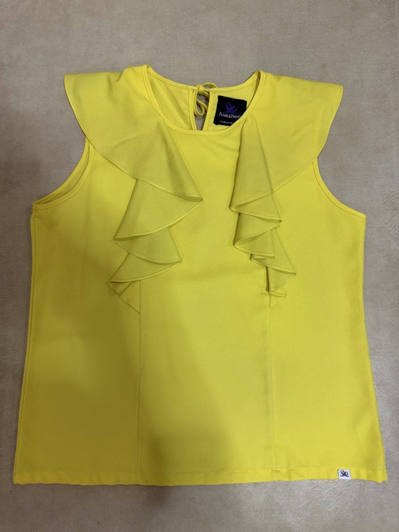 Plains & Prints Yellow Sleeveless Blouse with Ruffles (Category: Blouses) located in Manila. Submitted by abigailyao21949 (Listing ID 1463385688, Image 1). Description: Plains & Prints Yellow Sleeveless Blouse with Ruffles •Size: M •Color: Yellow •Style: Sleeveless with ruffles in front •Slightly used but still in very good condition.