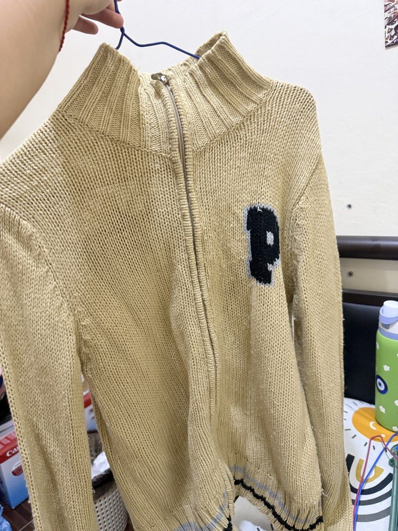 Playboy Zip-Up Knit Cardigan (Category: Coats, Jackets and Outerwear) located in Manila. Submitted by raini3e (Listing ID 1463342734, Image 1). Description: - Tan knit cardigan with zip-up front - Features 'P' initial on the chest - 'PLAYBOY' text with iconic bunny logo on the back - Ribbed collar and cuffs for a comfortable fit - Striped detail at the hem - Ideal for stylish layering.
