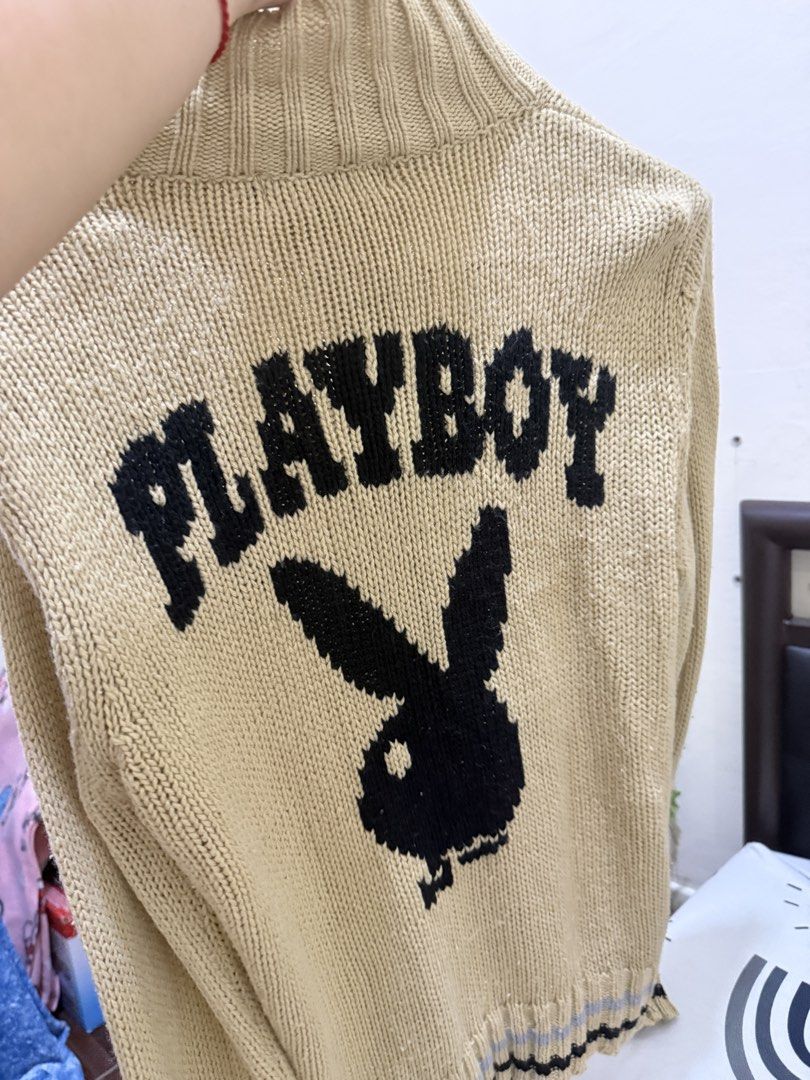 Playboy Zip-Up Knit Cardigan (Category: Coats, Jackets and Outerwear) located in Manila. Submitted by raini3e (Listing ID 1463342734, Image 2). Description: - Tan knit cardigan with zip-up front - Features 'P' initial on the chest - 'PLAYBOY' text with iconic bunny logo on the back - Ribbed collar and cuffs for a comfortable fit - Striped detail at the hem - Ideal for stylish layering.
