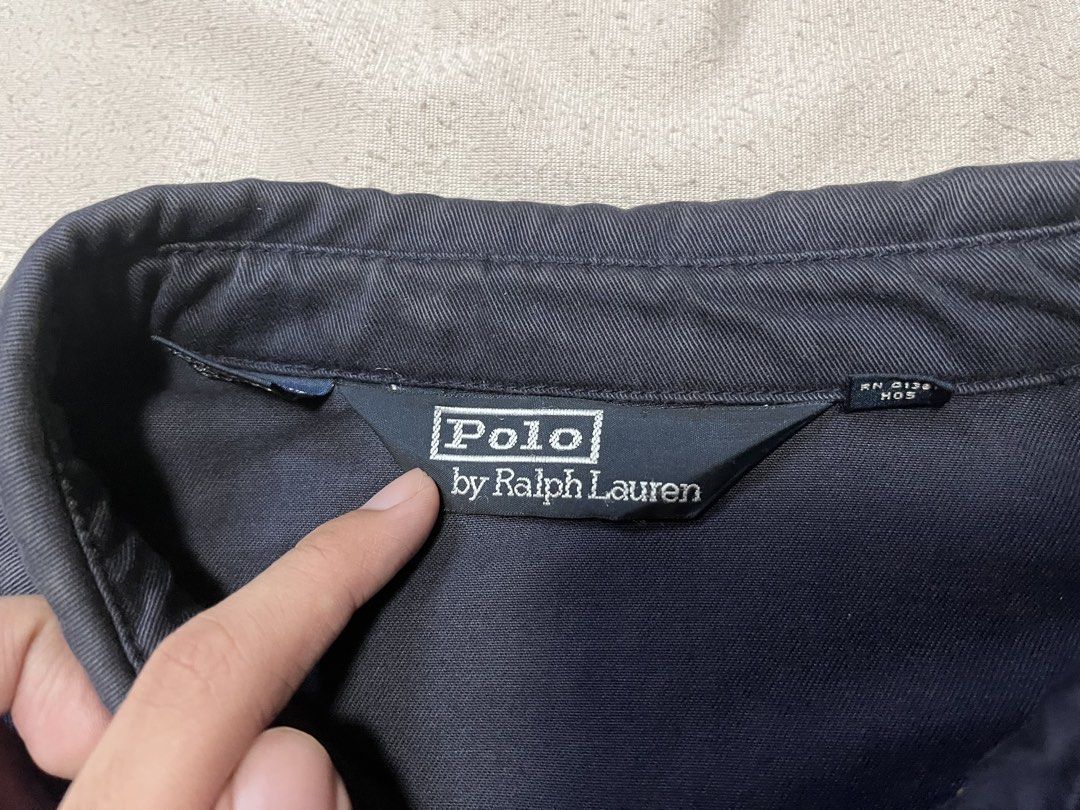 Polo Ralph Lauren Navy Harrington Jacket (Category: Coats, Jackets and Outerwear) located in Quezon City. Submitted by gvsfinds_ (Listing ID 1463492853, Image 3). Description: Authentic Ralph Lauren navy blue harrington jacket with red lining under the collar. Size: XL Dimensions: - Length: 28 - Width: 27 - Sleeve: 20 - Shoulder: 24 Issue: Patch on left sleeve. Price is negotiable..
