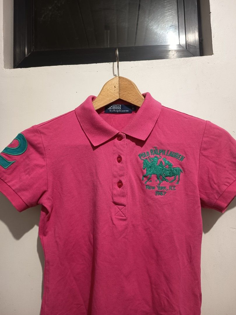 Polo Ralph Lauren Pink & Orange (2 pcs) (Category: Activewear) located in Bulacan. Submitted by dvsthrift (Listing ID 1463526440, Image 3). Description: - Authentic Polo Ralph Lauren polo shirts - Bright pink polo with green '2' graphic on sleeve and horse/rider graphic on front - Orange polo with navy blue '8' graphic on sleeve and two crests on front - Both are short-sleeved with classic button plackets - Perfect for stylish playdates and every