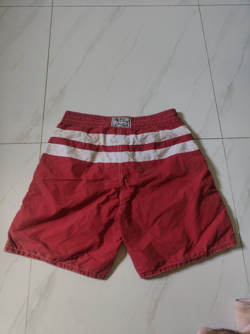 Polo Ralph reversible swim shorts (Category: Swim Trunks & Board Shorts) located in Legazpi City. Submitted by luckytree_09199b (Listing ID 1463358072, Image 2). Description: - Polo Ralph Lauren swim trunks - Reversible design: Red with white stripes on one side, plaid on the other - Elastic waistband with drawstring for adjustable fit - Button closure at the fly - Convenient side pockets - Ideal for beach or pool outings - Ready for summer fun!.