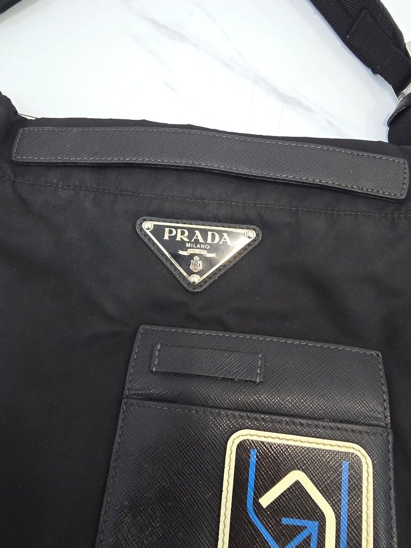 Prada Black Nylon Messenger Sling Bag (Category: Luxury Bags & Wallets) located in Las Pinas. Submitted by vanpru (Listing ID 1463433589, Image 2). Description: - Authentic Prada bag - Black nylon material - Iconic Prada triangle logo - Interior zippered pocket - 'Made in Italy' tag - Adjustable strap - Ideal for everyday use - Decluttering. bought from Japan. rarely used..