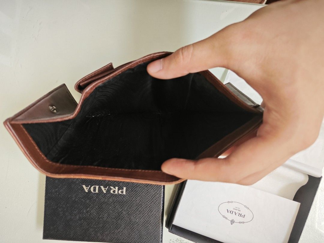 Prada Brown Croc Leather Bi-Fold Wallet (Category: Luxury Bags & Wallets) located in Manila. Submitted by hesunusual (Listing ID 1463354727, Image 3). Description: - Authentic Prada wallet - Rich brown croc-embossed leather - Classic bi-fold design - Multiple card slots - Convenient coin compartment - Includes original Prada box and dust bag - Expertly crafted in Italy.