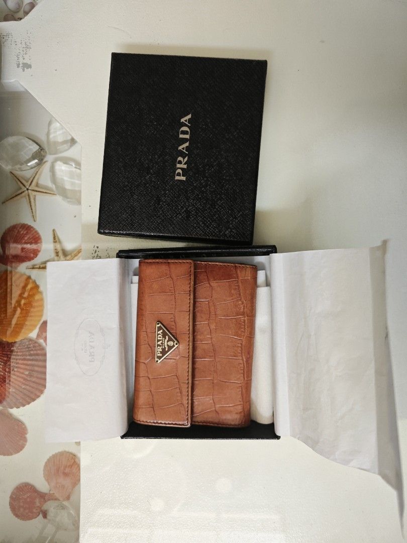 Prada Brown Croc Leather Bi-Fold Wallet (Category: Luxury Bags & Wallets) located in Manila. Submitted by hesunusual (Listing ID 1463354727, Image 1). Description: - Authentic Prada wallet - Rich brown croc-embossed leather - Classic bi-fold design - Multiple card slots - Convenient coin compartment - Includes original Prada box and dust bag - Expertly crafted in Italy.