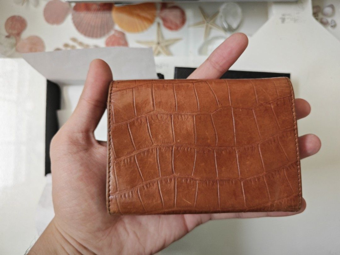 Prada Brown Croc Leather Bi-Fold Wallet (Category: Luxury Bags & Wallets) located in Manila. Submitted by hesunusual (Listing ID 1463354727, Image 2). Description: - Authentic Prada wallet - Rich brown croc-embossed leather - Classic bi-fold design - Multiple card slots - Convenient coin compartment - Includes original Prada box and dust bag - Expertly crafted in Italy.