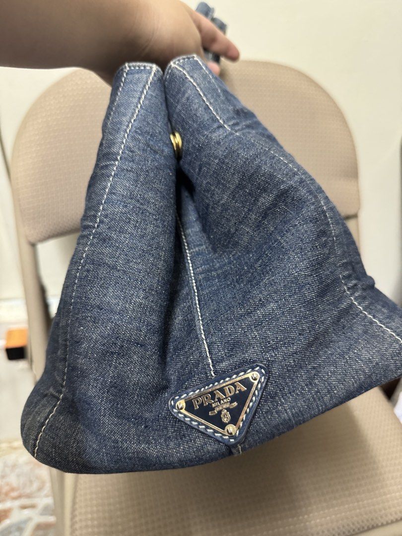 Prada Denim Tote Bag (Category: Luxury Bags & Wallets) located in Cabanatuan. Submitted by dgbordador (Listing ID 1463382599, Image 3). Description: - Classic Prada tote bag in stylish denim. - Features the iconic Prada logo prominently on the front. - Elegant gold hardware, including zipper and base studs. - Generously spacious interior, ideal for everyday essentials. - A timeless and chic accessory from Prada Milano..