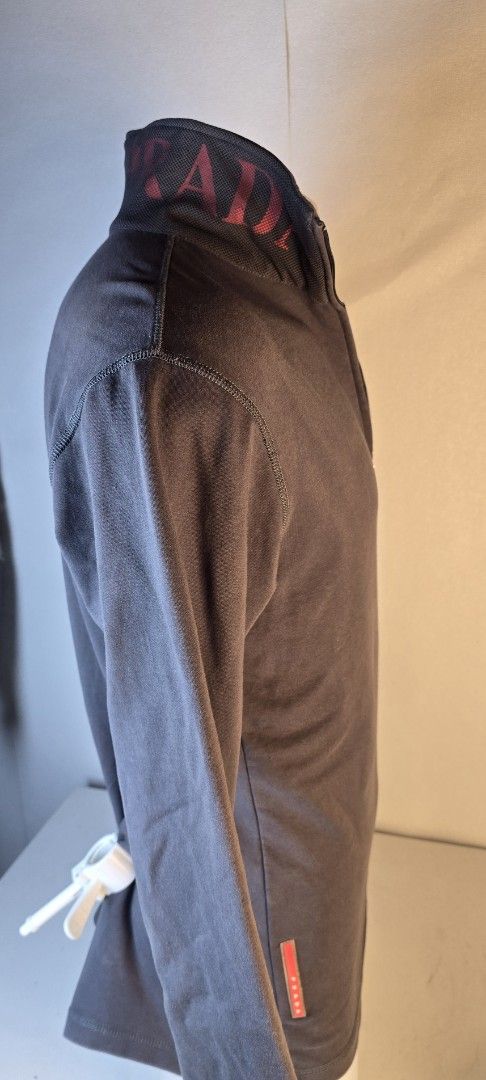 Prada Grey 1/4 Zip Sweatshirt (Category: Longsleeves) located in Pasig City. Submitted by dertah (Listing ID 1463434171, Image 2). Description: - Authentic Prada grey long-sleeved sweatshirt - Features a 1/4 zip closure with striking red lining - Subtle Prada logo elegantly embroidered on the chest - Small, iconic red Prada tag detail on the side - Ideal for a stylish and comfortable casual look -100% Authentic -100% Japan - Super Value for money