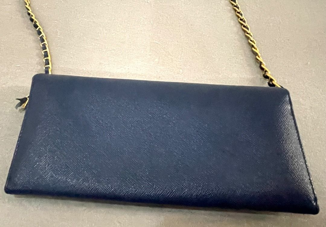 Prada Saffiano Leather Wallet on Chain Navy Blue (Category: Luxury Bags & Wallets) located in General Tinio. Submitted by the_bargainhunter (Listing ID 1463341856, Image 3). Description: - Navy blue Prada Saffiano leather wallet on chain - Gold hardware - Detachable chain strap for versatile wear (clutch or crossbody) - Interior features card slots and a zip pocket - Sold as is.
