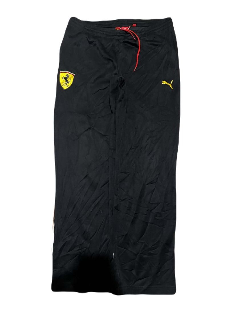 Puma Ferrari Black Track Pants (Category: Joggers) located in Santiago. Submitted by bakithrift (Listing ID 1463461617, Image 1). Description: - Authentic Puma x Ferrari collaboration track pants - Sleek black design with iconic logos - Features a vibrant red drawstring for adjustable comfort - Perfect for everyday casual wear or athletic activities - Offers a comfortable and relaxed fit.