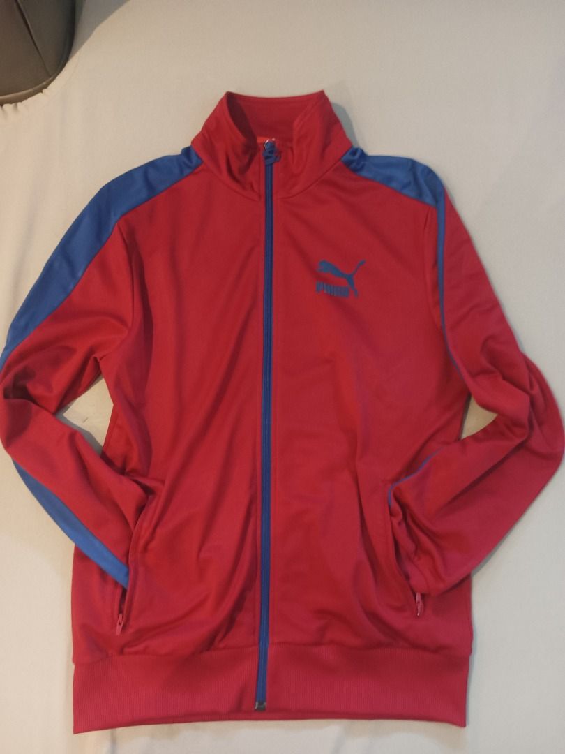 Puma Track Jacket (Category: Coats, Jackets and Outerwear) located in Muntinlupa City. Submitted by irene.aragon.navarro (Listing ID 1463358834, Image 1). Description: - Classic Puma track jacket - Bright red with blue sleeve and collar accents - Full zip front closure - Two zippered pockets - Ribbed cuffs and hem for a snug fit - Ideal for casual wear or athletic activities.