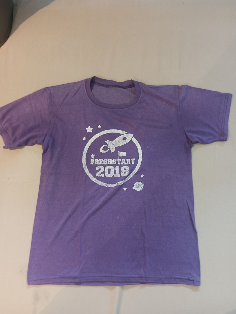 Purple Tee Shirt (Category: Tshirts & Polo Shirts ) located in Muntinlupa City. Submitted by irene.aragon.navarro (Listing ID 1463353196, Image 1). Description: - Color: Purple - Graphic: Cool rocket with 'Freshstart 2018' text - Neckline: Round - Sleeves: Short - Graphic Color: Silver-white - Style: Fun for events or casual wear.