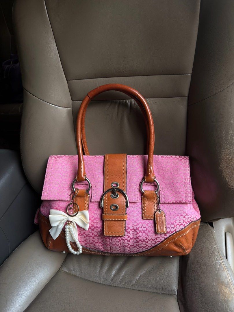 Rare Coach Pink Monogram Soho Flap (Category: Luxury Bags & Wallets) located in Dumaguete. Submitted by braveforest-2a12 (Listing ID 1463336264, Image 1). Description: - Cute pink Coach monogram shoulder bag - Brown leather trim and handles - Decorative bow and pearl charm attached - Secure buckle closure on front flap - Ideal for everyday use.