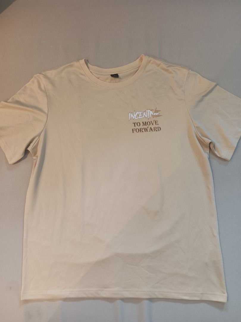 Raw Gold Tee Shirt (Category: Tshirts & Polo Shirts ) located in Muntinlupa City. Submitted by irene.aragon.navarro (Listing ID 1463348536, Image 1). Description: - Light beige t-shirt - Features a small chest graphic: "INCENTIVE TO MOVE FORWARD" - Simple and comfortable design - Ideal for casual wear.