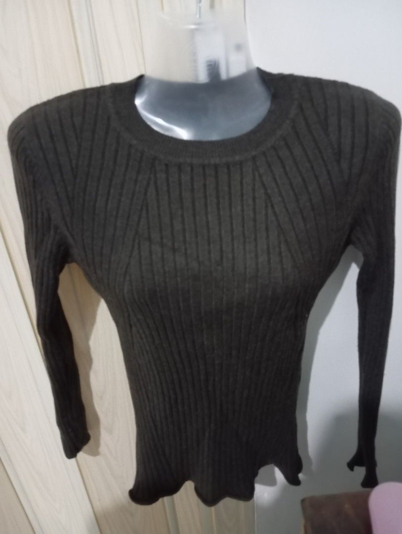 Ribbed Long Sleeve Sweater (Category: Longsleeves) located in Dasmarinas. Submitted by kei05 (Listing ID 1463440273, Image 1). Description: - Dark grey ribbed knit sweater - Long sleeves - Fitted silhouette - Classic crew neck - Slight ruffle detail at the hem - Stretchy and comfortable material - Perfect for layering.