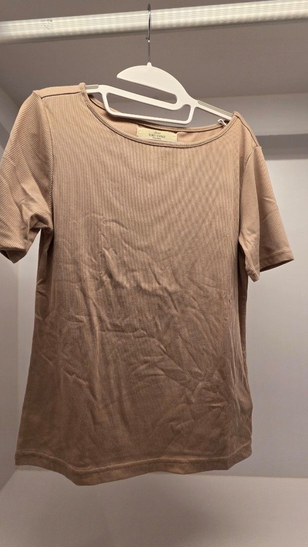 Ribbed Top (Category: Shirts) located in Mandaluyong City. Submitted by loijiminigo (Listing ID 1463457643, Image 1). Description: - Brand: Closet Staples - Style: Ribbed cropped t-shirt - Features: Short sleeves, crew neck - Material: Soft, stretchy fabric - Color: Light beige/tan - Fit: Cropped - Occasion: Everyday wear, versatile basic.