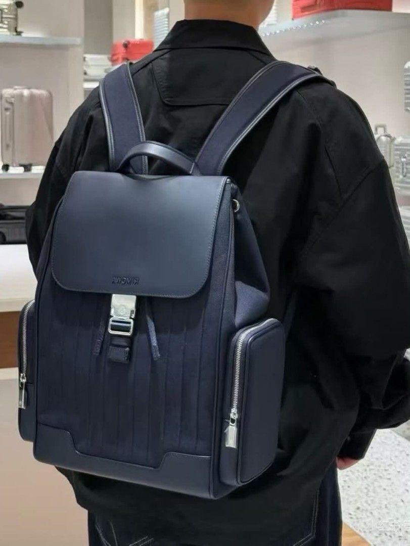 Rimowa Navy Blue Backpack (Category: Backpacks) located in Paoay. Submitted by rvf1230 (Listing ID 1463336642, Image 1). Description: - Navy blue Rimowa backpack - Made in Italy - Flap closure with buckle and drawstring - Two zippered side pockets - Padded back panel and adjustable straps for comfort - Interior zippered pocket - Coordinates visible on back panel and inside label.
