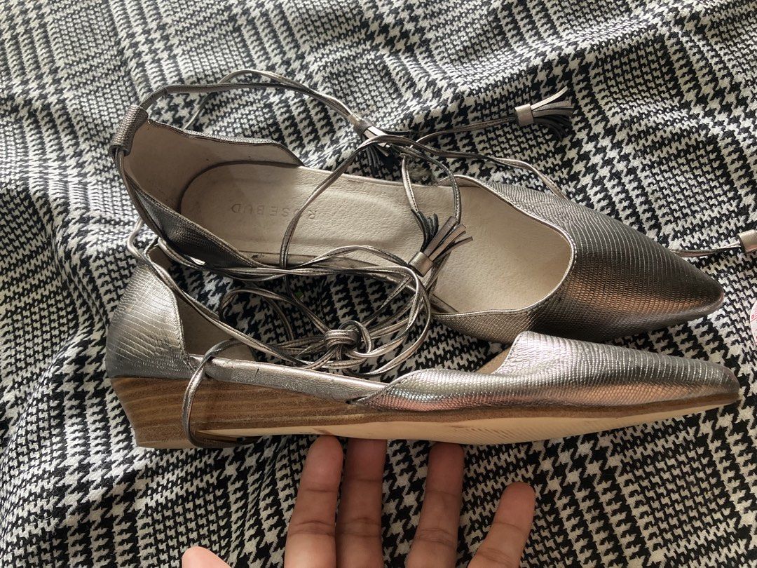 Rosebud flat pointed shoe (Category: Flats & Sandals) located in Angeles City. Submitted by jnwsurplus (Listing ID 1463366394, Image 1). Description: These appear to be metallic silver pointed-toe ankle-wrap flat shoes featuring delicate wraparound lace ties with tassel details..