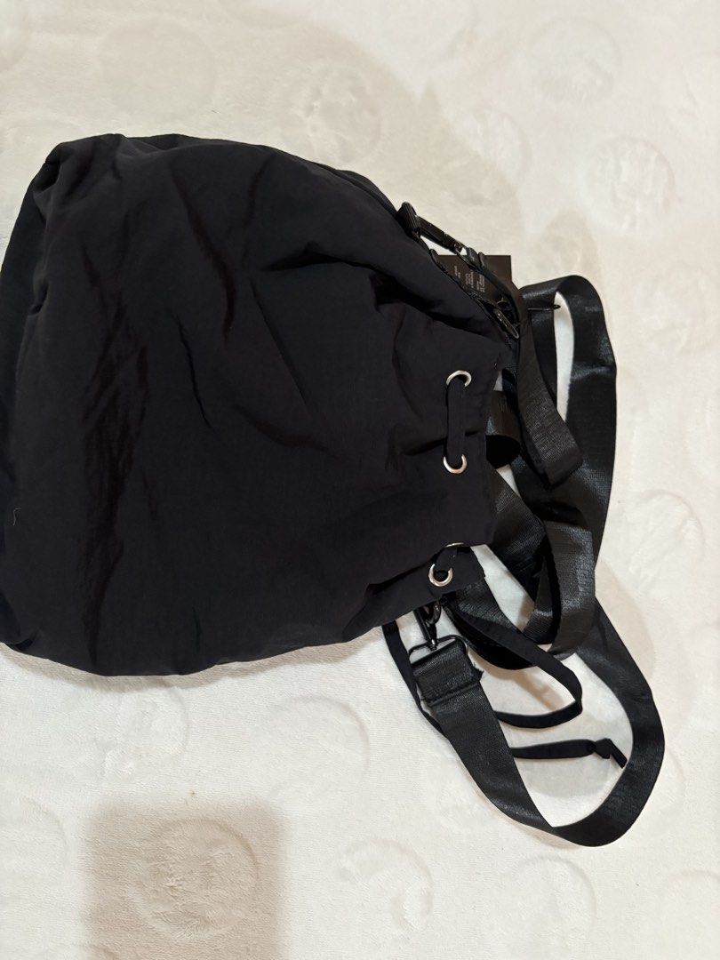 Salvatore Mann Black Nylon Drawstring Backpack (Category: Backpacks) located in Manila. Submitted by dig76 (Listing ID 1463357597, Image 2). Description: - Salvatore Mann black drawstring backpack - Main compartment - Front zip pocket - Two smaller front pockets with button closures - Adjustable straps - Ideal for everyday use or travel - Clean inside and out.