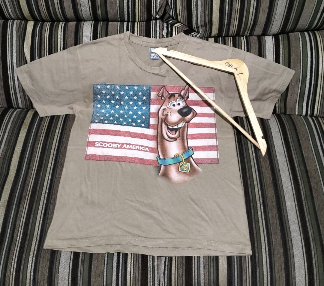 Scooby Doo America T-Shirt (Category: Tshirts & Polo Shirts ) located in Taguig. Submitted by conniemdcruz (Listing ID 1463485380, Image 1). Description: - Features a cool Scooby Doo graphic with an American flag. - Light tan colored t-shirt. - Ideal for casual wear and Scooby Doo fans. vintage Scooby Doo both size med dated 1998 and 2002 both in very good condition 600 aspack.