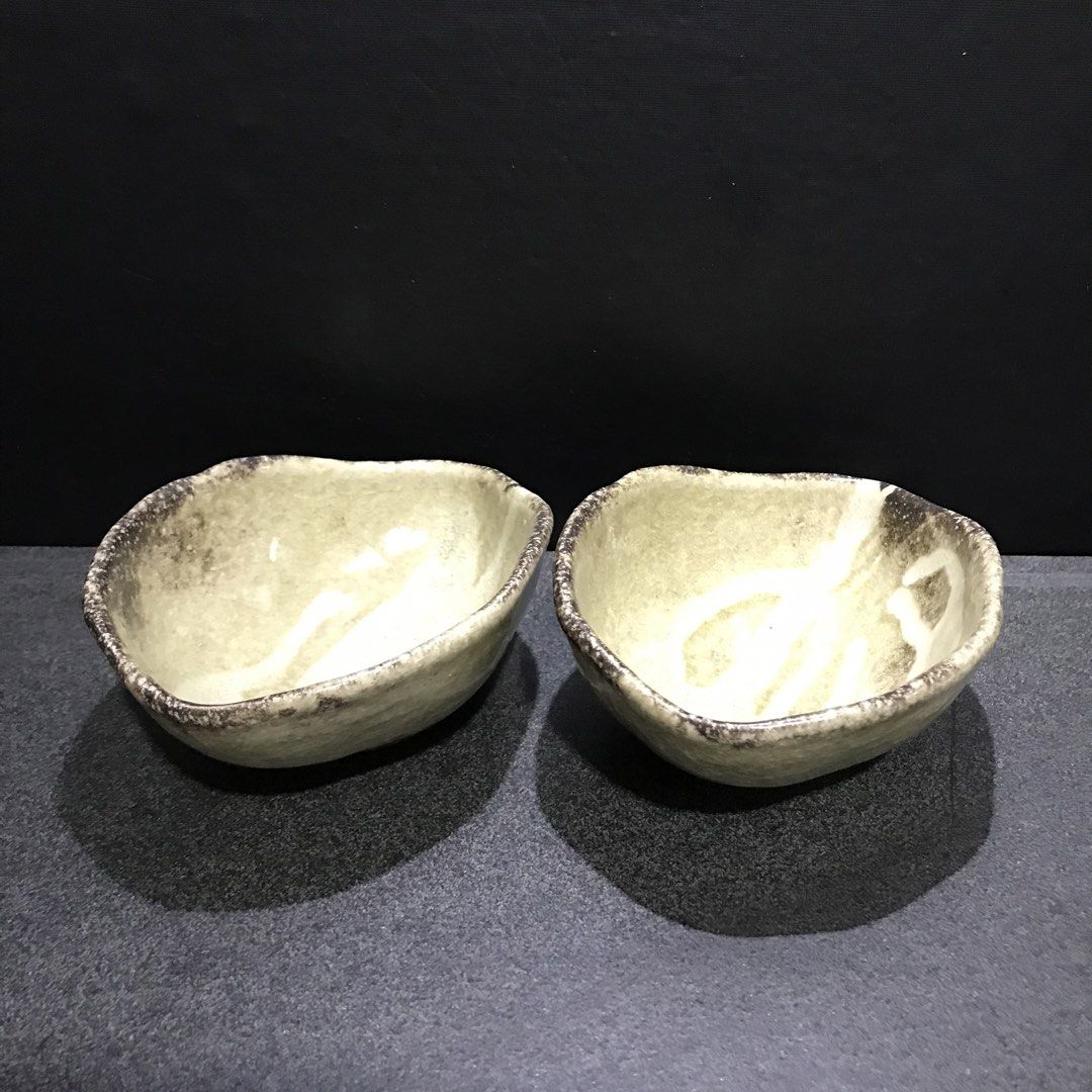 Set of 2 Handmade Ceramic Bowls (Category: Dinnerware & Cutlery) located in Baao. Submitted by all.things.japan (Listing ID 1463550547, Image 1). Description: 4.5 x 6.0 x 2.5 inches - Set of 2 unique ceramic bowls - Rustic, handmade aesthetic - Textured glaze with charming irregular edges - Ideal for serving snacks, dips, or as decorative pieces - Clean foot ring on the bottom.