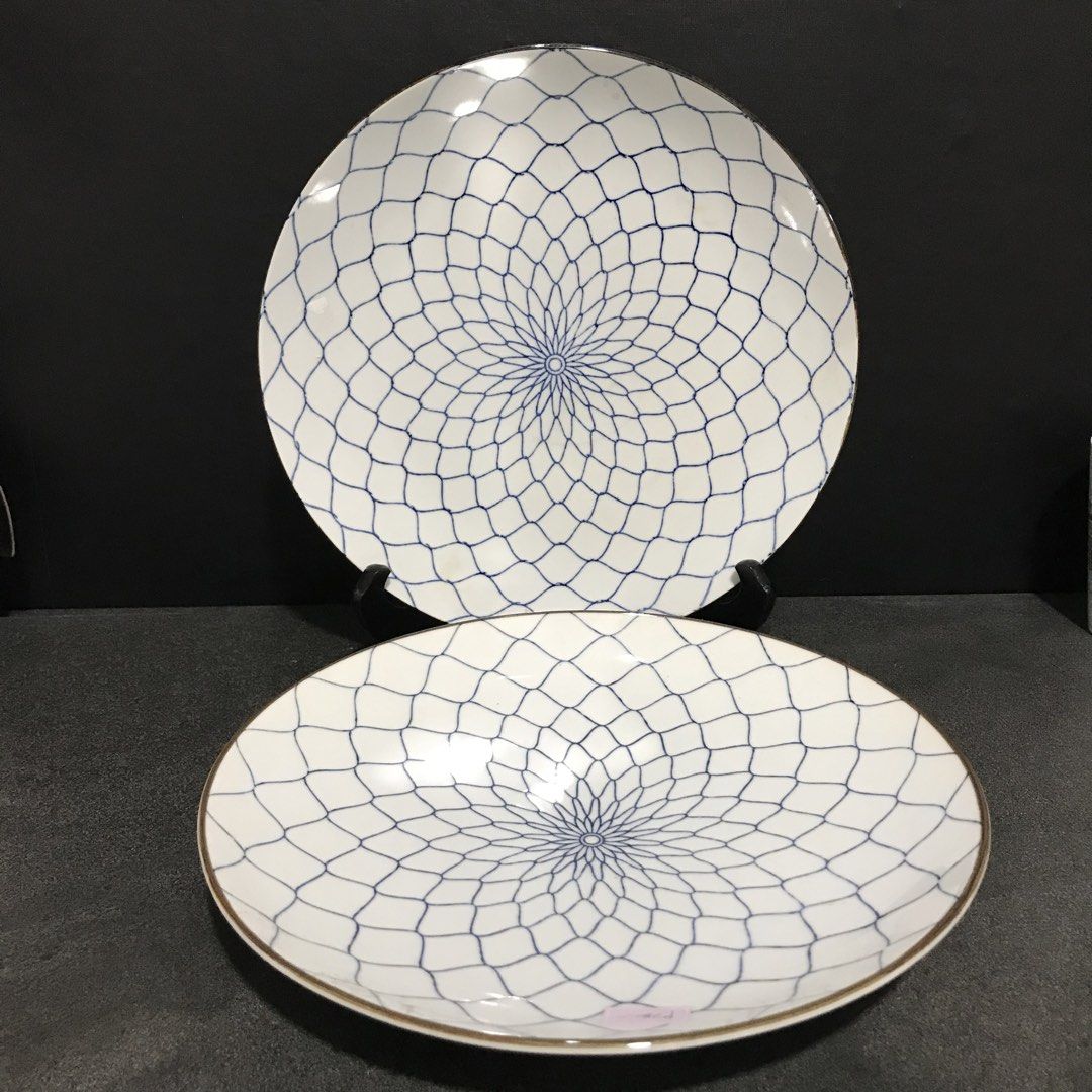 Set of 2 White Blue Patterned Ceramic Plates (Category: Dinnerware & Cutlery) located in Baao. Submitted by all.things.japan (Listing ID 1463366552, Image 1). Description: P240.00 each -Set of 2 beautiful ceramic plates - White base with a striking blue geometric pattern radiating from the center - Elegant subtle gold trim along the edges - Versatile: great for serving food or as decorative display pieces - One plate features a blue stamp on the 