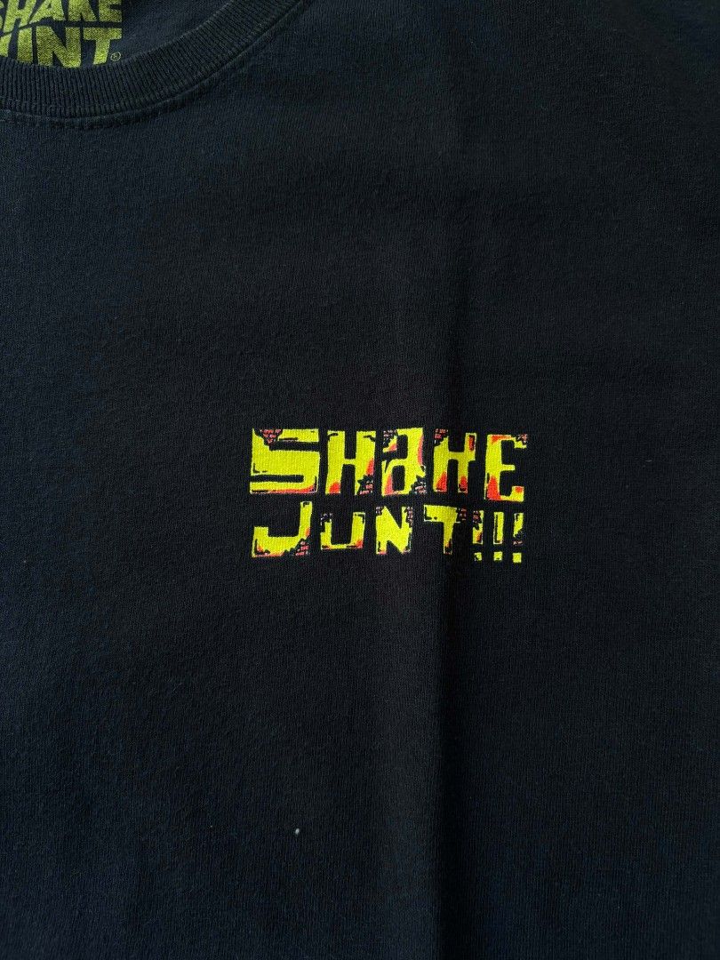 Shake Junt Graphic T-Shirt (Category: Tshirts & Polo Shirts ) located in Iriga City. Submitted by thrifttobicol29 (Listing ID 1463450248, Image 3). Description: - Black t-shirt - Features a cool graphic of a bird character in a city scene on the back - Small logo on the front chest - Perfect for casual everyday wear - Shake junt Medium W 19" L 28" Excellent condition .