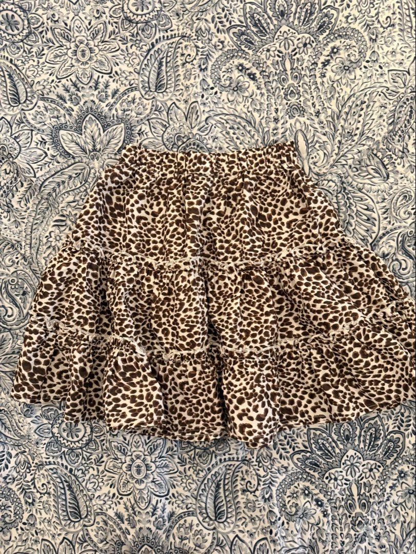 SHEIN Leopard Print Tiered Mini Skirt XS (Category: Skirts) located in Dasmarinas. Submitted by declutter.mai (Listing ID 1463406803, Image 1). Description: - Adorable leopard print mini skirt from SHEIN - Features a trendy tiered, ruffled design - Comfortable elastic waistband for a perfect fit - Size XS - Versatile for casual outings or dressing up.