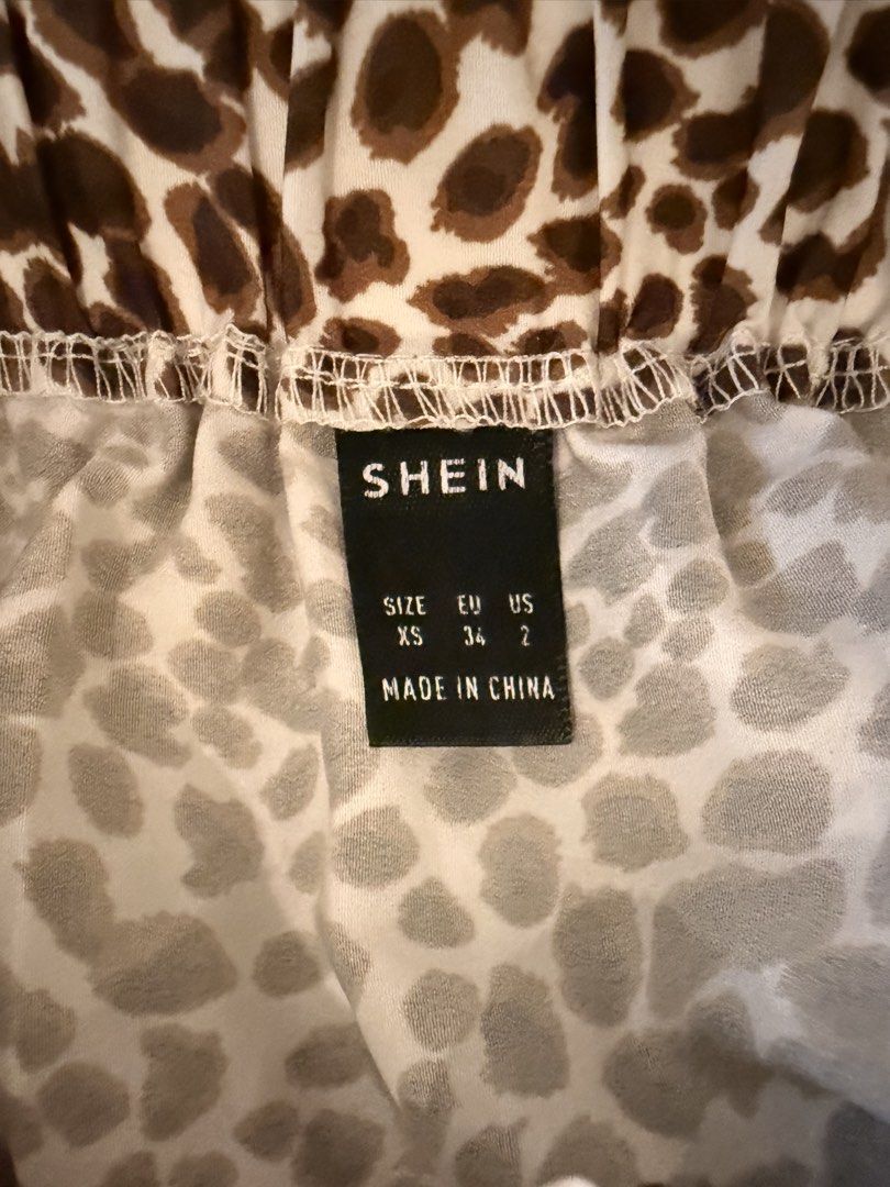 SHEIN Leopard Print Tiered Mini Skirt XS (Category: Skirts) located in Dasmarinas. Submitted by declutter.mai (Listing ID 1463406803, Image 3). Description: - Adorable leopard print mini skirt from SHEIN - Features a trendy tiered, ruffled design - Comfortable elastic waistband for a perfect fit - Size XS - Versatile for casual outings or dressing up.