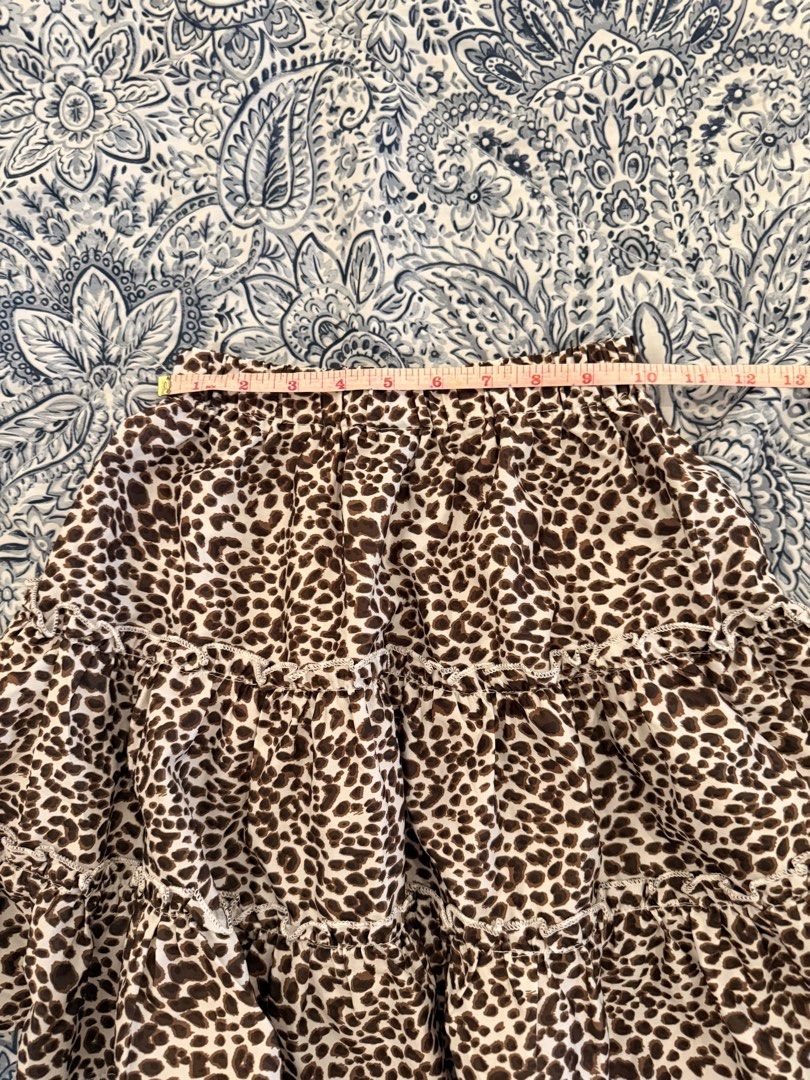 SHEIN Leopard Print Tiered Mini Skirt XS (Category: Skirts) located in Dasmarinas. Submitted by declutter.mai (Listing ID 1463406803, Image 2). Description: - Adorable leopard print mini skirt from SHEIN - Features a trendy tiered, ruffled design - Comfortable elastic waistband for a perfect fit - Size XS - Versatile for casual outings or dressing up.
