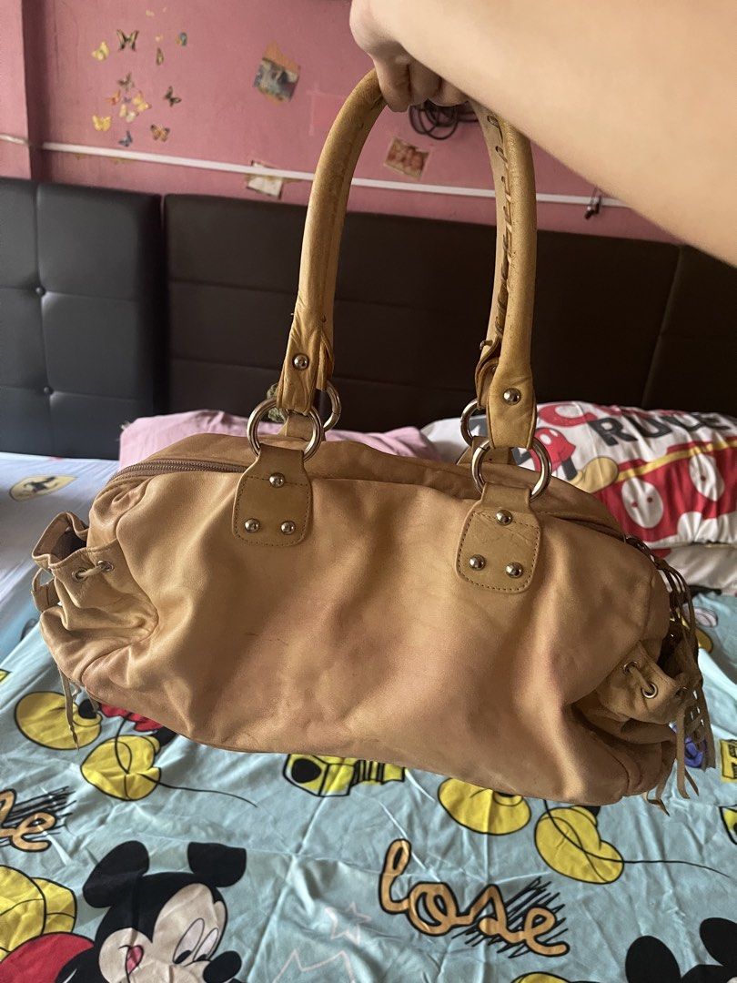 Sherry Wolf Bag (Category: Luxury Bags & Wallets) located in Quezon City. Submitted by rish40 (Listing ID 1463403278, Image 2). Description: - keychains/charms and items inside bag not included - Tan leather shoulder bag by Sherry Wolf - Genuine leather - Secure zip closure - Vibrant pink interior lining - Ample space for your essentials - Comes with a cute crocheted cherry charm - Ideal for everyday use.