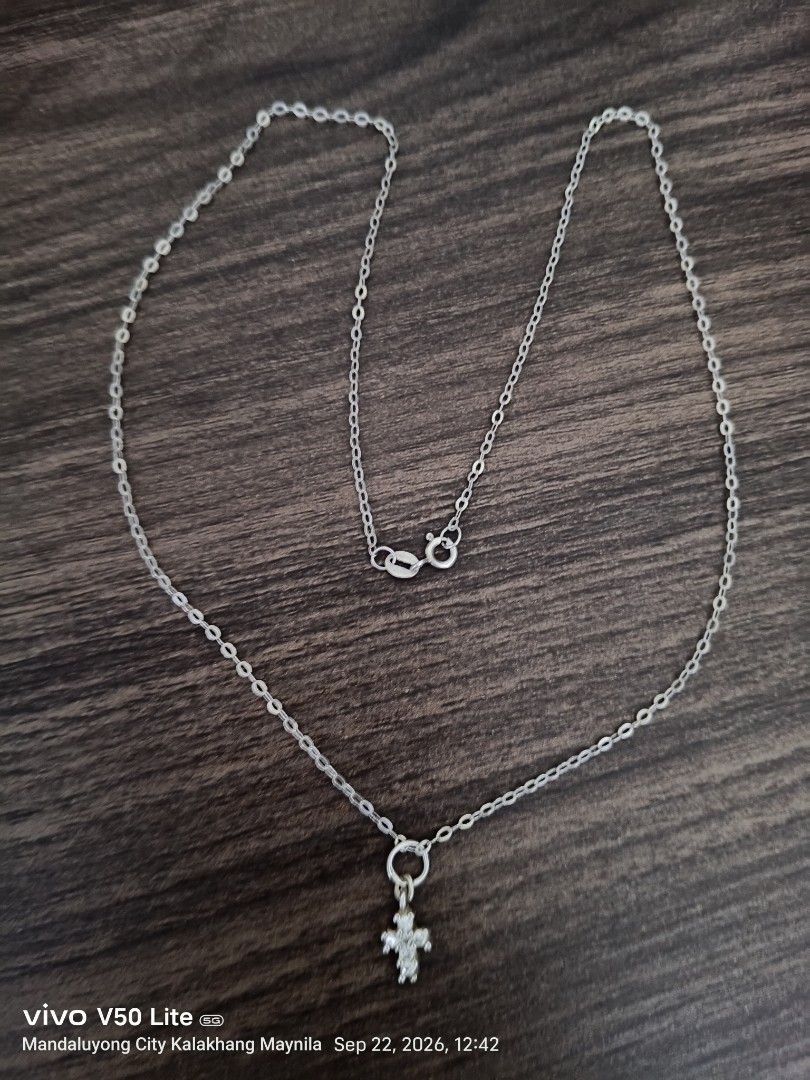 Silver Chain Necklace with cross Pendant (Category: Necklaces) located in Manila. Submitted by prettylook48762 (Listing ID 1463367487, Image 2). Description: - Simple silver chain necklace - Features a small cross pendant with clear stones - Secure clasp closure - Ideal for everyday wear or layering - Versatile, matches most outfits.