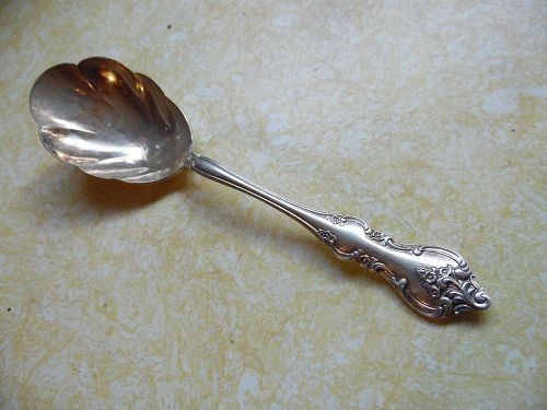 Silver Plated Serving Spoon with Ornate Handle (Category: Dinnerware & Cutlery) located in Tacloban City. Submitted by jikiri.b (Listing ID 1463372175, Image 1). Description: - Silver-plated serving spoon - Features a decorative handle with floral scrollwork - Scalloped edge on the spoon bowl - Ideal for serving desserts or side dishes - Adds a classic and elegant touch to your table setting.