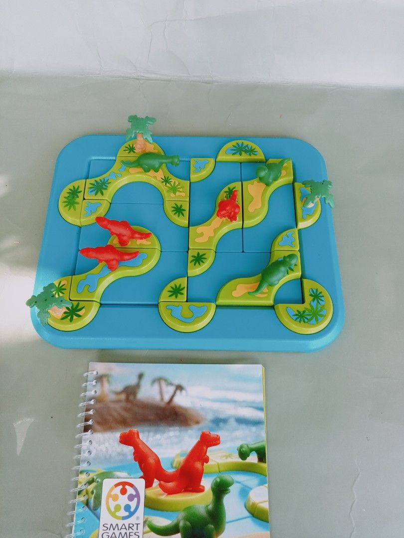 SmartGames Mystic Islands (Category: Board Games & Puzzles) located in Rosario. Submitted by elysedeclutter (Listing ID 1463379834, Image 1). Description: - Fun dinosaur-themed logic puzzle game for kids. - Helps develop problem-solving skills. - Comes with game board, dinosaur pieces, and challenge booklet. - Perfect for travel or quiet playtime..