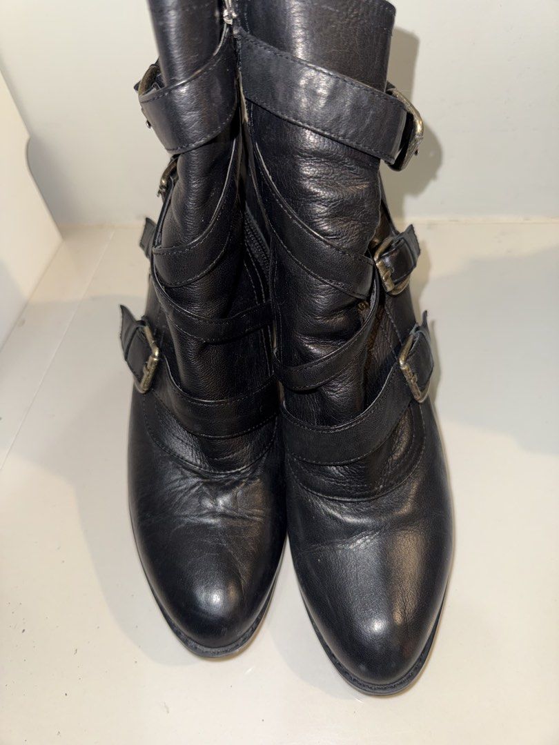 Soda Black Leather Buckle Ankle Boots (Category: Boots) located in Manila. Submitted by bellarhianna777 (Listing ID 1463332962, Image 2). Description: - Soda black leather ankle boots - Multiple buckle straps with antique gold hardware - Side zipper for easy wear - Approximately 3-inch heel height - Soles show some wear - Inner lining features Soda logo.
