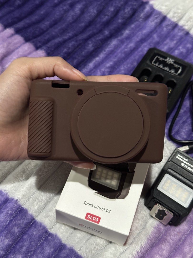 Sony ZV1 Accessories (Category: Other Photography Accessories) located in San Fernando. Submitted by nishsh_ (Listing ID 1463498685, Image 2). Description: - Ulanzi Spark Lite SL03 LED light - JJC NP-BX1 battery charger with USB cable - Brown silicone camera case -All for Sony ZV1 -Ulanzi & JJC Charger are both working -LIKE NEW (2 weeks palang nasa akin) -RFS: sold the cam. buyer shoulder sf Mode of Payment: Bank Transfer (BPI/ Maribank) GCash.