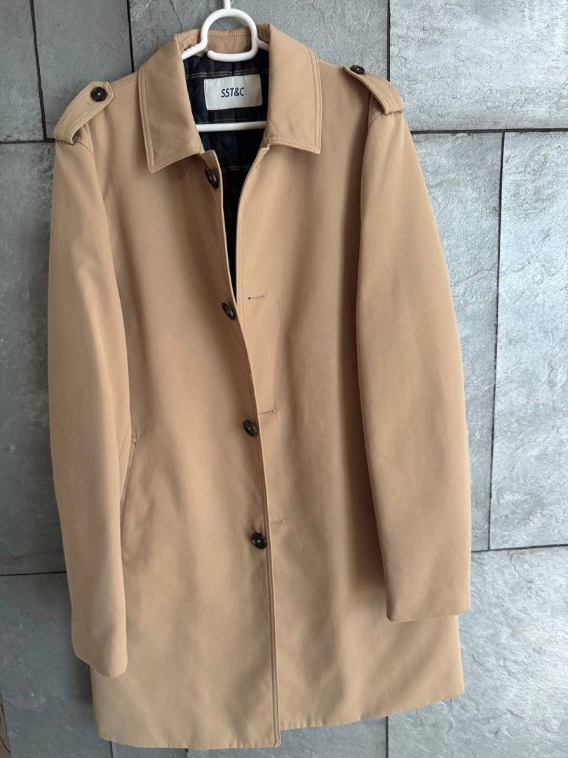 SST&C Beige Trench Coat (Category: Coats, Jackets and Outerwear) located in Taguig. Submitted by anxmz (Listing ID 1463404487, Image 1). Description: - Classic beige trench coat from SST&C - Button-up front with a collared neckline - Features a stylish plaid lining - Ideal for layering over any outfit - Adds a sharp and stylish touch to your look.