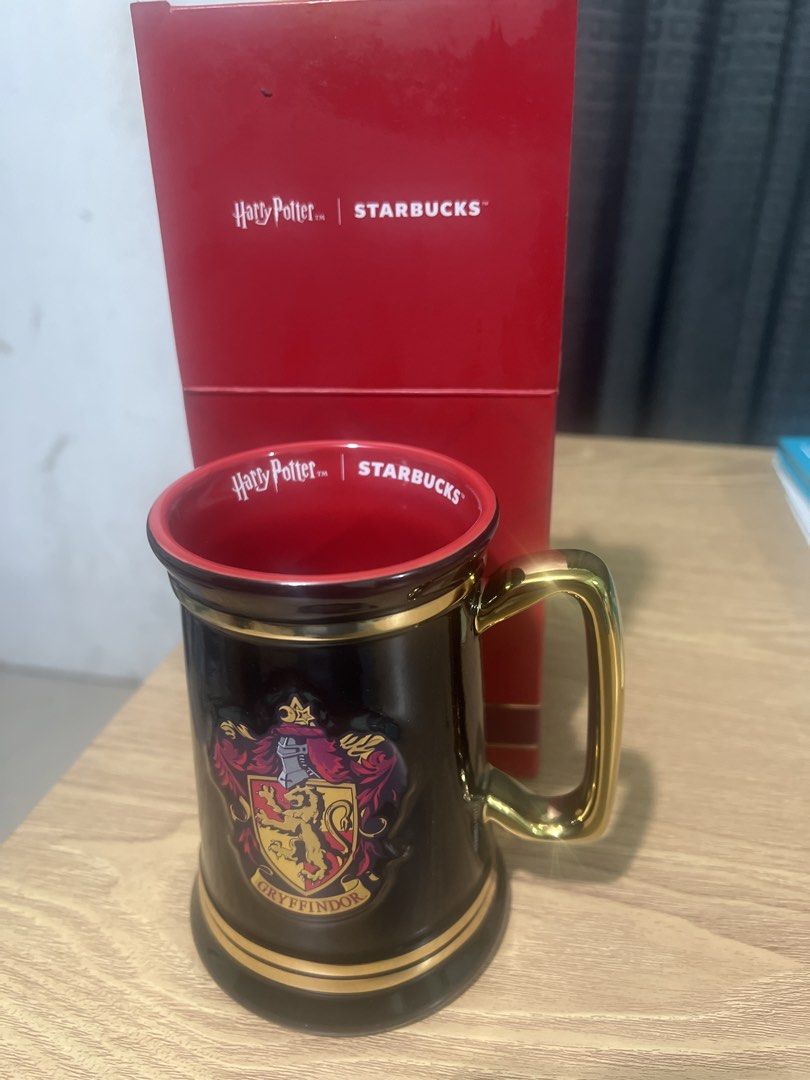 Starbucks Harry Potter Gryffindor Mug with Box (Category: Coffee & Tea Tableware) located in Manila. Submitted by cleverstone_21f597 (Listing ID 1463327781, Image 2). Description: - Authentic Starbucks Harry Potter Gryffindor Mug - Features the iconic Gryffindor crest in gold accents on a black mug - Comes with its original, collectible red box - Ideal for any Harry Potter enthusiast or mug collector - Perfect for enjoying your favorite hot bever