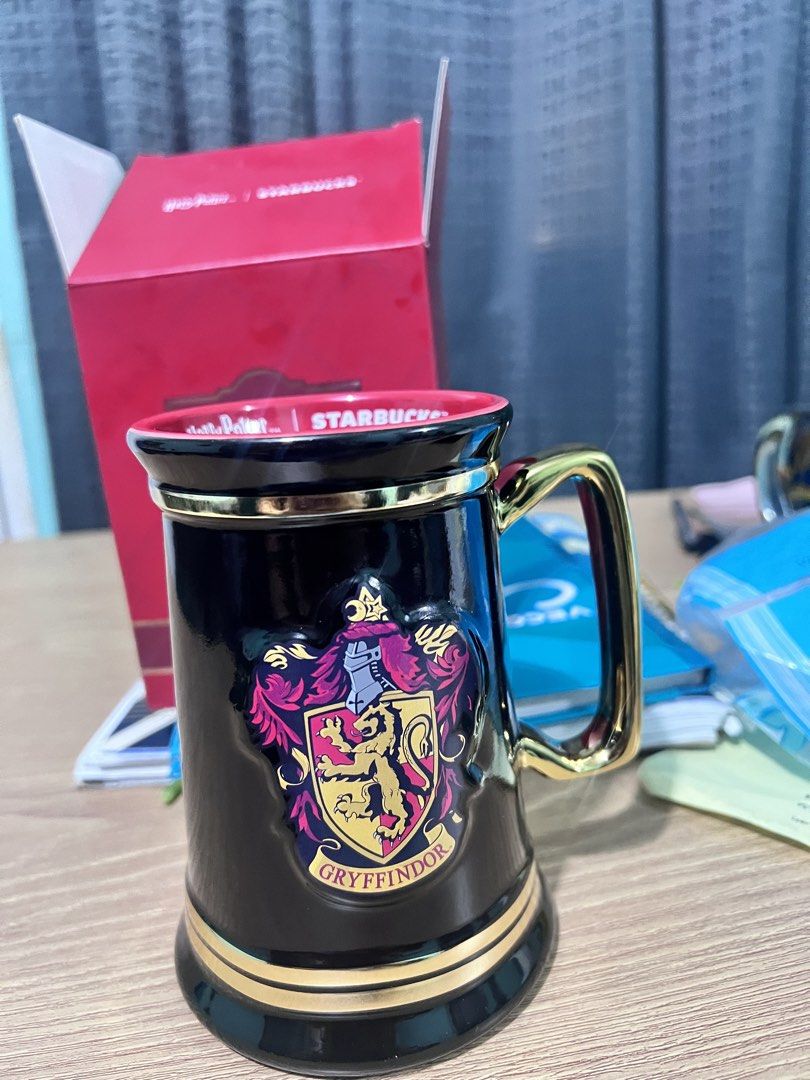 Starbucks Harry Potter Gryffindor Mug with Box (Category: Coffee & Tea Tableware) located in Manila. Submitted by cleverstone_21f597 (Listing ID 1463327781, Image 1). Description: - Authentic Starbucks Harry Potter Gryffindor Mug - Features the iconic Gryffindor crest in gold accents on a black mug - Comes with its original, collectible red box - Ideal for any Harry Potter enthusiast or mug collector - Perfect for enjoying your favorite hot bever
