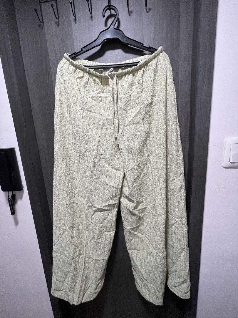 Stradivarius Light Green Textured Wide Leg Pants (Category: Other Bottoms) located in Makati City. Submitted by cm_preloved (Listing ID 1463510458, Image 1). Description: - Light green pants from Stradivarius - Textured fabric with brown vertical stripes - Comfortable elastic waistband with drawstring - wide-leg silhouette - Size XL - barely used.