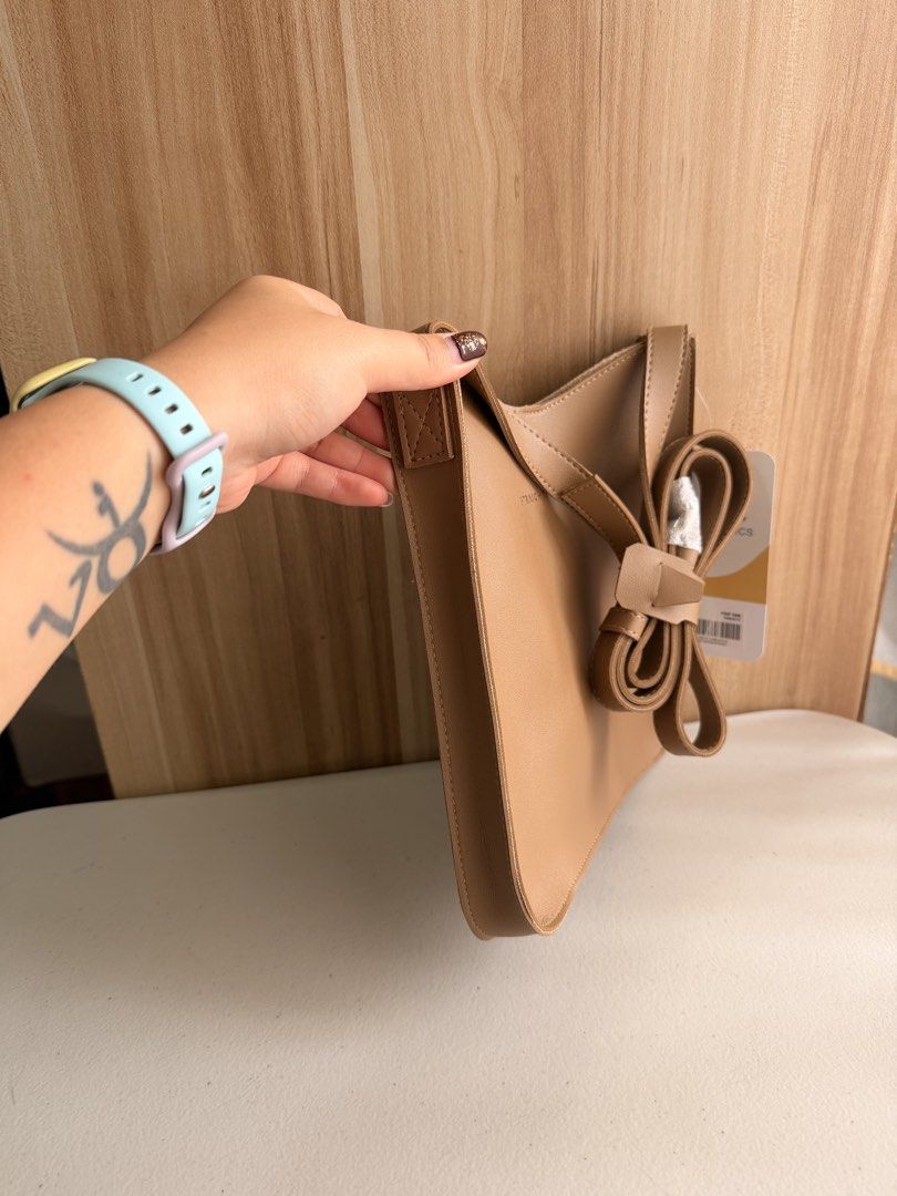 Straightforward Boundless Basics Sling Bag - Beige (Category: Cross-body Bags) located in Manila. Submitted by mondaymom (Listing ID 1463370421, Image 2). Description: - Brand: Boundless Basics - Color: Beige - Style: Chic sling bag - Features: Adjustable strap - Ideal for: Everyday use - Condition: Comes with original tag - Measurements: Approx. 23cm (Width) x 26cm (Height).
