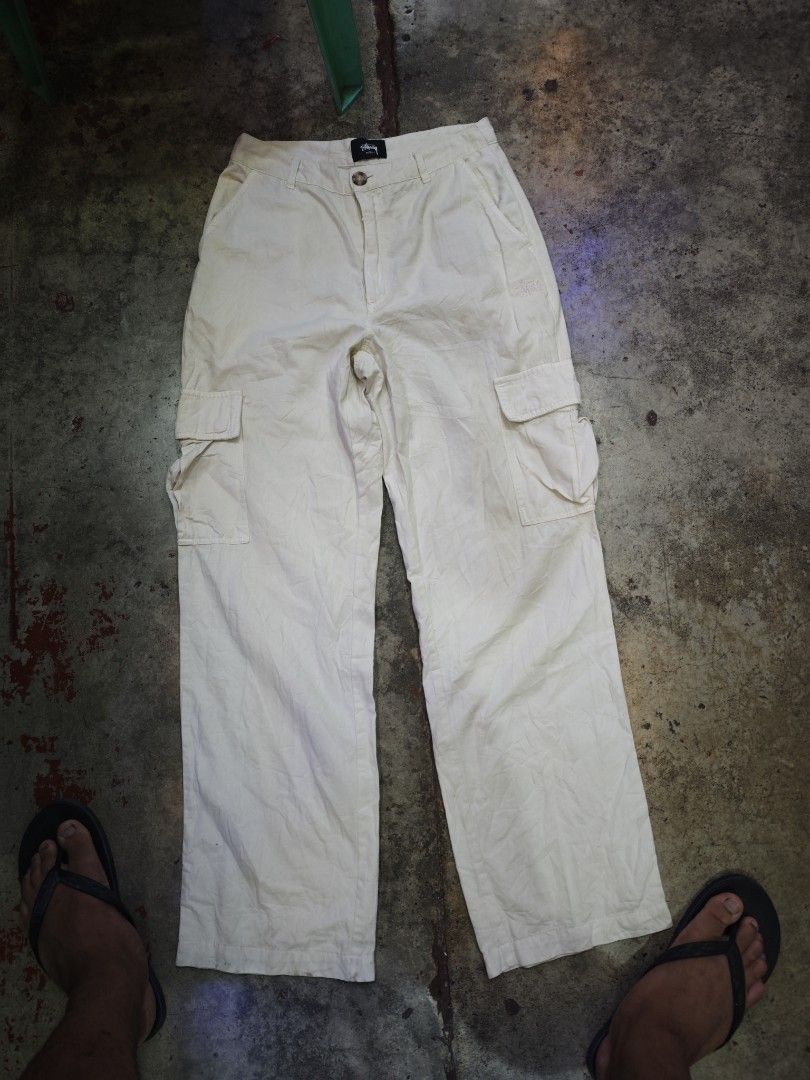 Stussy Cargo Pants Off White/ Cream White (Category: Joggers) located in Dalaguete. Submitted by three7archives (Listing ID 1463435124, Image 1). Description: - Stussy beige cargo pants - Classic cargo style with multiple pockets - Embroidered Stussy logo on the leg - Button closure at the waist - Made in China - Material: Cotton PS Need Wash.