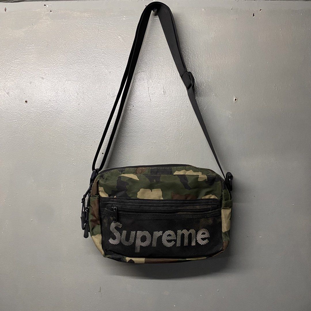 Supreme Camo Shoulder Bag (Category: Luxury Bags & Wallets) located in Cagayan de Oro. Submitted by sumamestreethub (Listing ID 1463431113, Image 1). Description: - Authentic Supreme camo print shoulder bag - Features a mesh front pocket with iconic Supreme logo - Multiple zippered compartments for ample storage - Adjustable strap for comfortable wear - Made in Canada - Crafted from 100% Cotton.