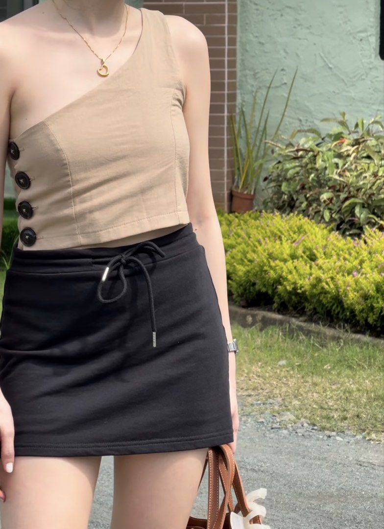 Tan One Shoulder Crop Top with Button Detail (Category: Sleeveless) located in Bacolod City. Submitted by bacolodprelovedstuffs (Listing ID 1463375003, Image 3). Description: - Tan one-shoulder crop top - Features three dark buttons on the side - Versatile: pairs well with skirts or high-waisted pants - Comfortable and stylish for casual outings or nights out - please see more photos for WW.