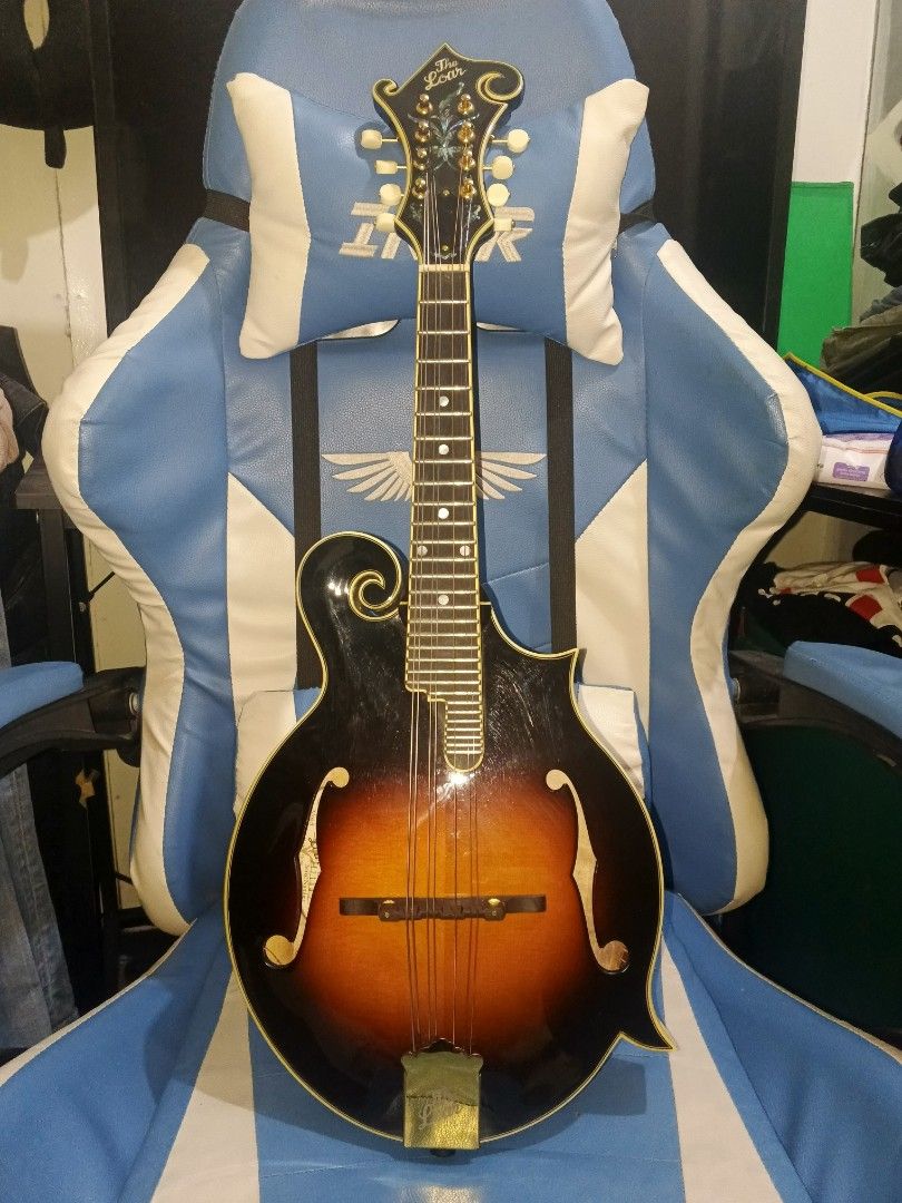 The Loar F-Style Mandolin + Hard Case (Category: Musical Instruments) located in Nagcarlan. Submitted by myste.ree (Listing ID 1463514360, Image 1). Description: 🎶 FOR SALE: THE LOAR F-STYLE MANDOLIN + HARD CASE 🎶 Letting go of this beautiful The Loar F-style Mandolin 🎻 ✨ Gorgeous vintage sunburst finish ✨ Classic F-style design ✨ Beautiful detailed headstock & body ✨ Comes with hard protective case ✨ Well-kept and ready for its next owner Per