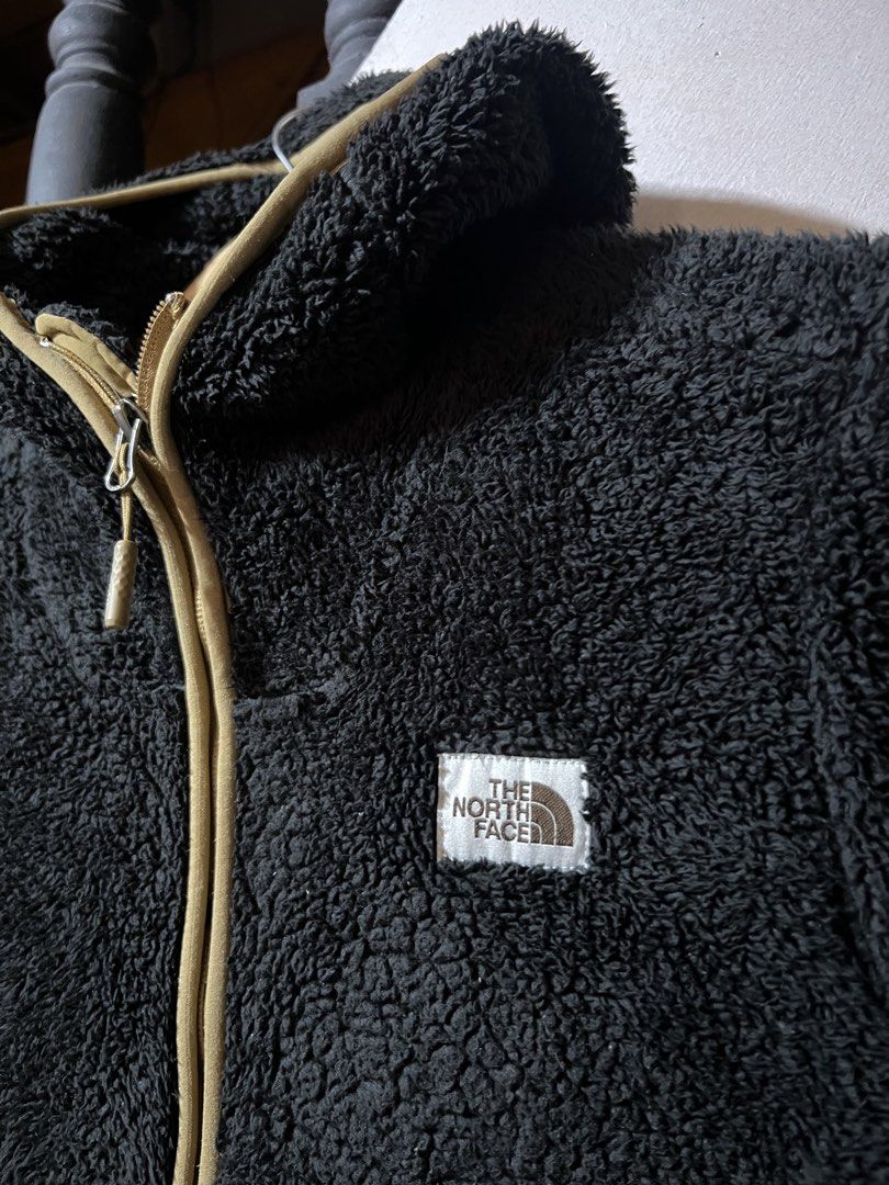 The North Face Black Fleece Pullover (Category: Coats, Jackets and Outerwear) located in Butuan. Submitted by nikthrift. (Listing ID 1463334766, Image 2). Description: - Brand: The North Face - Type: Black fleece pullover - Accents: Tan zipper and pocket details - Material: 100% Polyester - Features: Great for layering, comfortable, warm - Ideal for: Outdoor activities or casual wear.