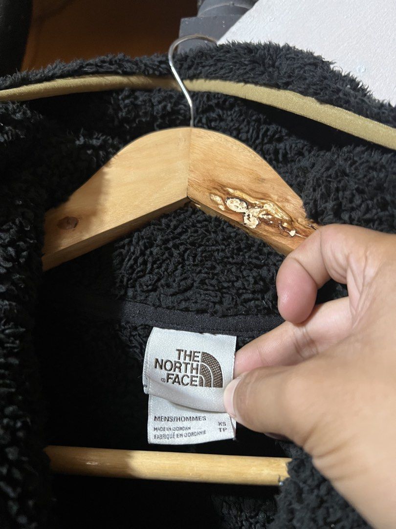 The North Face Black Fleece Pullover (Category: Coats, Jackets and Outerwear) located in Butuan. Submitted by nikthrift. (Listing ID 1463334766, Image 3). Description: - Brand: The North Face - Type: Black fleece pullover - Accents: Tan zipper and pocket details - Material: 100% Polyester - Features: Great for layering, comfortable, warm - Ideal for: Outdoor activities or casual wear.
