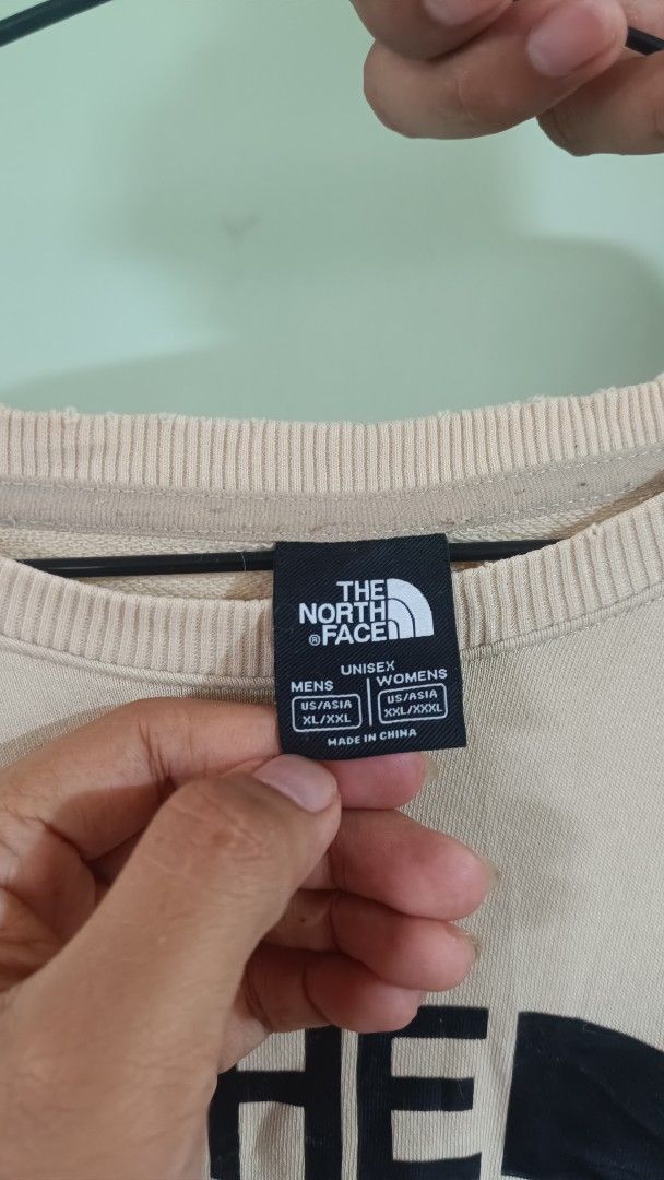 The North Face Crewneck Sweatshirt (Category: Coats, Jackets and Outerwear) located in Taguig. Submitted by redarmy21775000 (Listing ID 1463344371, Image 2). Description: - Brand: The North Face - Color: Light Pink - Style: Crewneck Sweatshirt - Features: Classic logo and 'Never Stop - need wash Exploring' text - Sizing: Unisex US/Asia XL/XXL - Ideal for: Casual wear and everyday adventures.